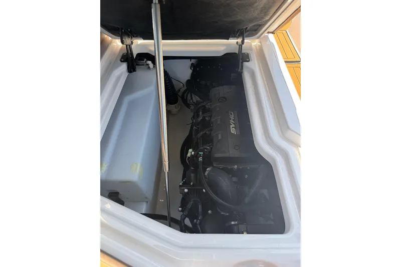 Slide: The Image of Engine compartment of 2025 Yamaha Boats 275SE, showcasing internal components and storage. - 31