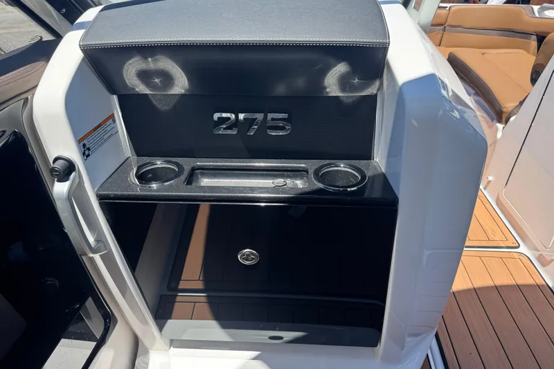 Slide: The Image of 2025 Yamaha Boats 275SE interior with cup holders and storage compartment. - 32