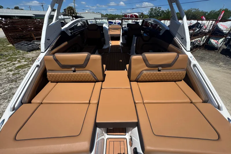 Slide: The Image of 2025 Yamaha Boats 275SE interior with luxurious tan seating and spacious layout. - 5