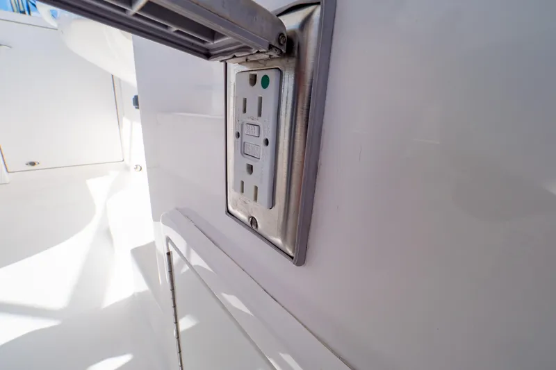Slide: The Image of Electrical outlet on 2018 Intrepid 475 Sport Yacht, featuring a sleek, modern design. - 106
