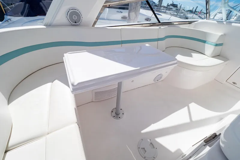 Slide: The Image of Luxurious seating area on 2018 Intrepid 475 Sport Yacht with white and teal accents. - 108
