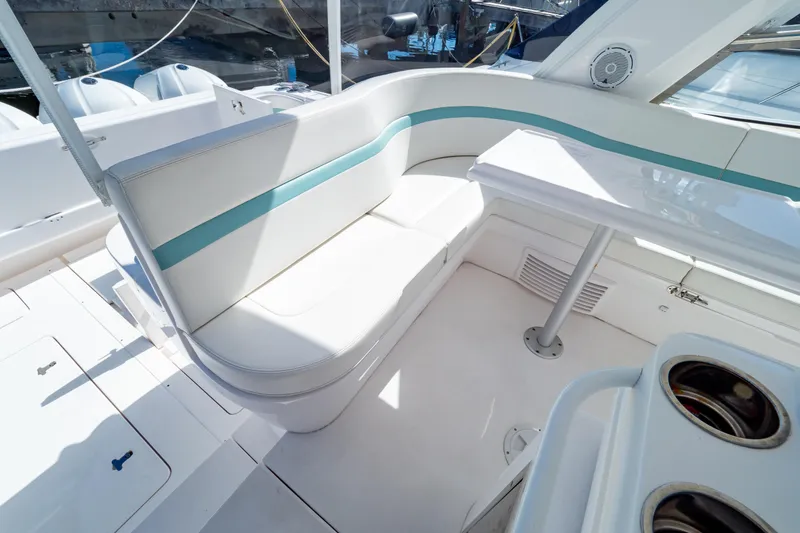 Slide: The Image of Luxurious seating area on a 2018 Intrepid 475 Sport Yacht, featuring white and teal upholstery. - 111