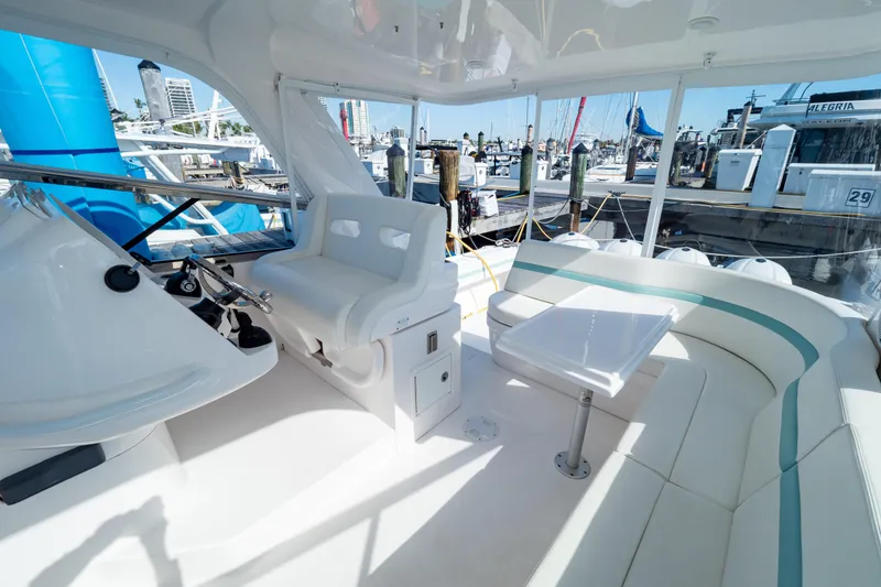 Slide: The Image of Luxurious 2018 Intrepid 475 Sport Yacht interior with seating and helm, docked at marina. - 112