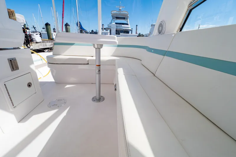 Slide: The Image of Interior view of 2018 Intrepid 475 Sport Yacht with white seating and table. - 118