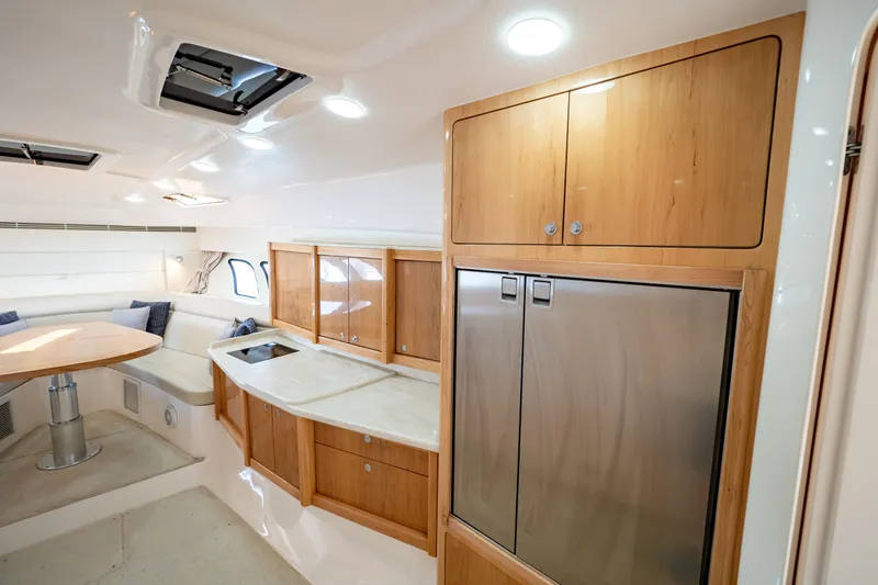 Slide: The Image of Luxurious interior of 2018 Intrepid 475 Sport Yacht with modern kitchen and seating area. - 124
