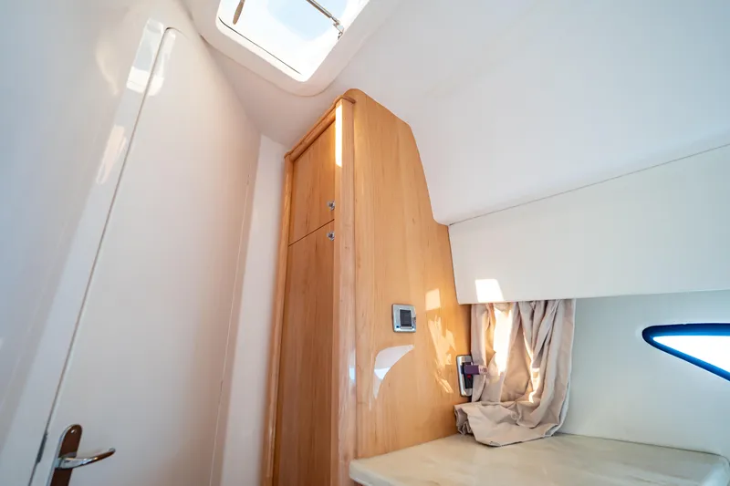 Slide: The Image of Interior of 2018 Intrepid 475 Sport Yacht with wooden cabinetry and skylight. - 132