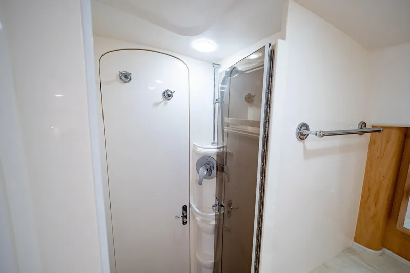 Slide: The Image of 2018 Intrepid 475 Sport Yacht bathroom with shower and towel rack. - 134
