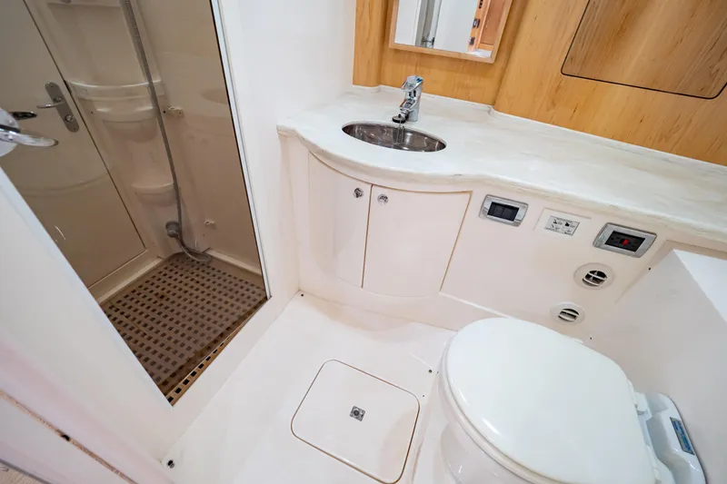 Slide: The Image of Luxurious bathroom in 2018 Intrepid 475 Sport Yacht with shower, sink, and toilet. - 14