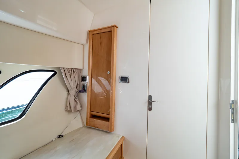 Slide: The Image of Interior of 2018 Intrepid 475 Sport Yacht with wooden cabinet and window. - 144