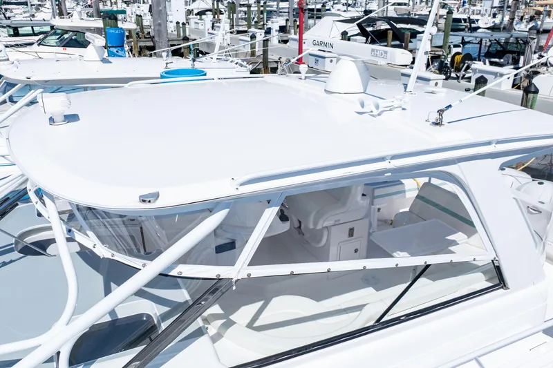 Slide: The Image of 2018 Intrepid 475 Sport Yacht docked, showcasing sleek design and modern features. - 17