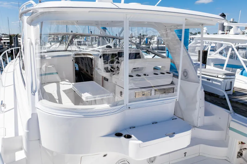 Slide: The Image of 2018 Intrepid 475 Sport Yacht with sleek white design docked at marina. - 25