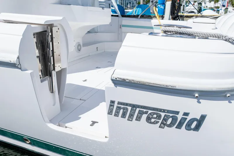 Slide: The Image of 2018 Intrepid 475 Sport Yacht, white exterior, docked, open deck view. - 28