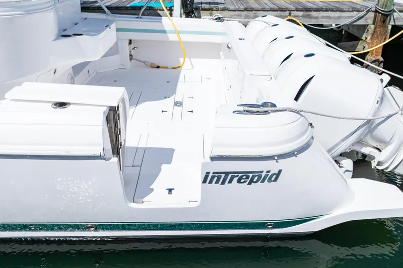 Slide: The Image of 2018 Intrepid 475 Sport Yacht docked, showcasing sleek design and powerful engines. - 29