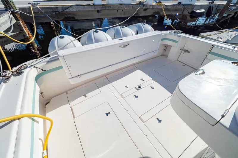 Slide: The Image of 2018 Intrepid 475 Sport Yacht deck with storage compartments and outboard engines. - 45