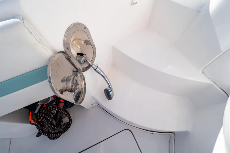 Slide: The Image of 2018 Intrepid 475 Sport Yacht shower fixture and coiled hose on deck. - 50