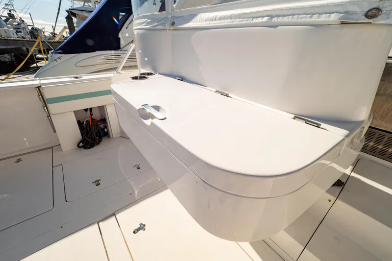 Slide: The Image of 2018 Intrepid 475 Sport Yacht interior with sleek white seating and storage. - 53