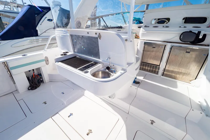 Slide: The Image of 2018 Intrepid 475 Sport Yacht interior with kitchenette and stainless steel appliances. - 54