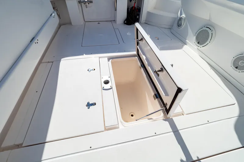 Slide: The Image of 2018 Intrepid 475 Sport Yacht deck with open storage compartment. - 59