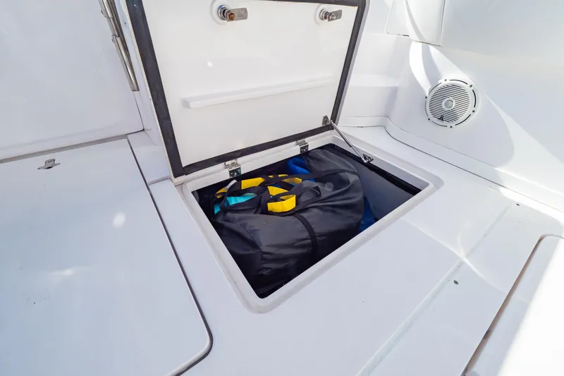Slide: The Image of Storage compartment on 2018 Intrepid 475 Sport Yacht with gear bag inside. - 60