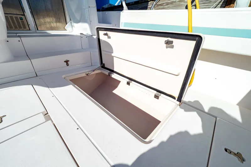Slide: The Image of Open storage compartment on 2018 Intrepid 475 Sport Yacht deck, showcasing spacious interior. - 61