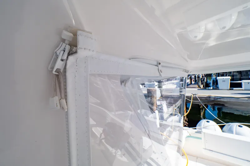 Slide: The Image of 2018 Intrepid 475 Sport Yacht with clear enclosure and dock view. - 73