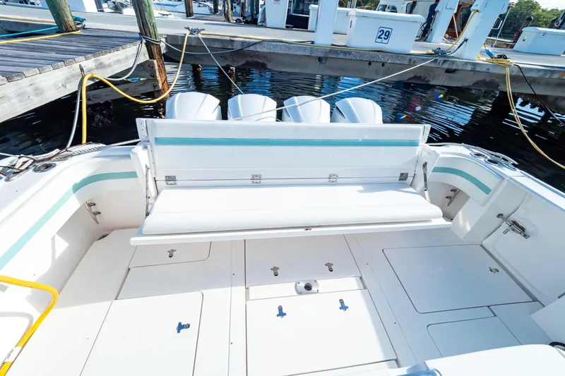 Slide: The Image of 2018 Intrepid 475 Sport Yacht with spacious deck and seating at marina. - 8