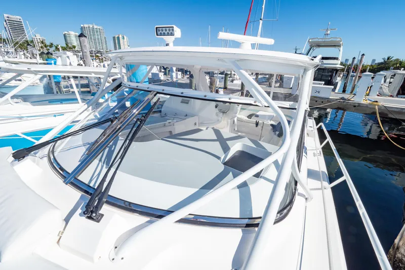 Slide: The Image of 2018 Intrepid 475 Sport Yacht docked at marina under clear blue sky. - 81