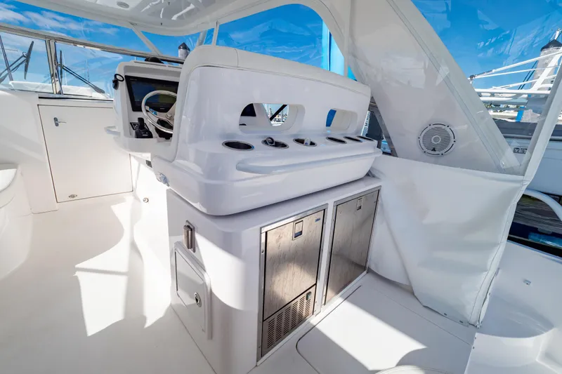 Slide: The Image of 2018 Intrepid 475 Sport Yacht interior with helm station and storage cabinets. - 88