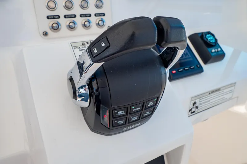 Slide: The Image of Control panel of a 2018 Intrepid 475 Sport Yacht with throttle and buttons. - 98