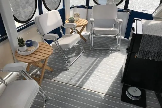 Slide: The Image of 1993 Carver 370 Aft Cabin Motor Yacht interior with chairs and small tables. - 13