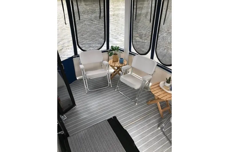 Slide: The Image of Interior of 1993 Carver 370 Aft Cabin Motor Yacht with chairs and tables. - 15