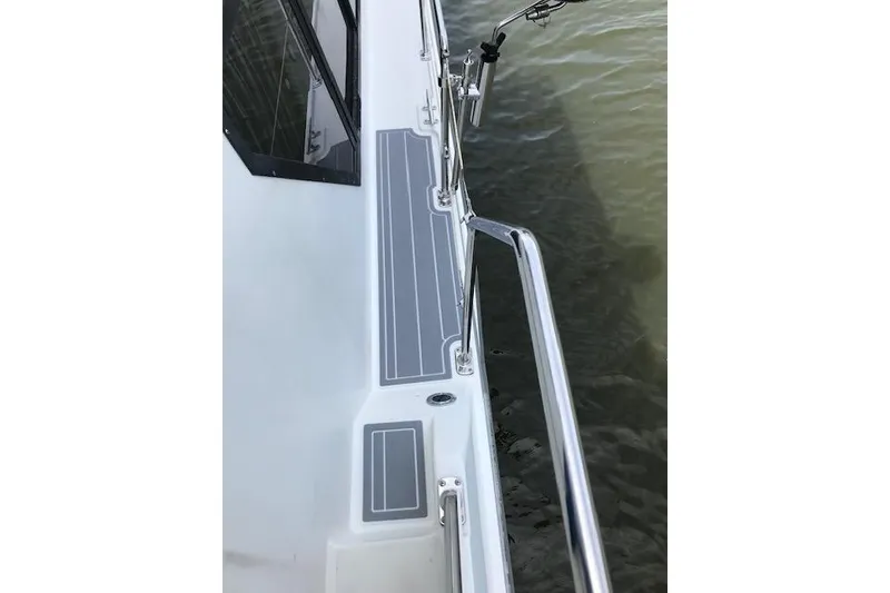Slide: The Image of 1993 Carver 370 Aft Cabin Motor Yacht deck with railing and water view. - 16