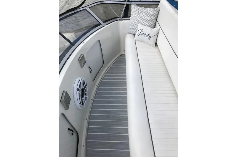 Slide: The Image of 1993 Carver 370 Aft Cabin Motor Yacht interior with white seating and decorative pillows. - 22