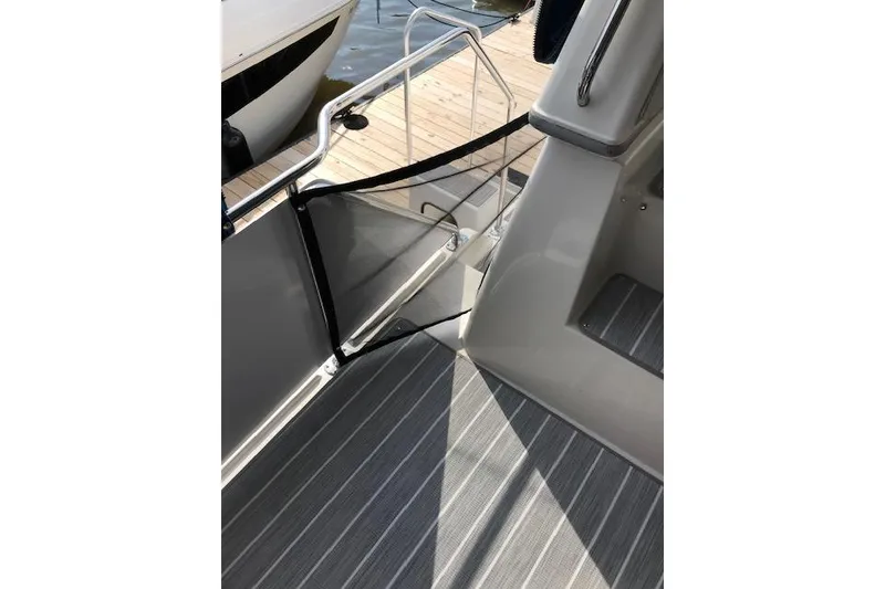 Slide: The Image of 1993 Carver 370 Aft Cabin Motor Yacht deck with railing and dock view. - 24