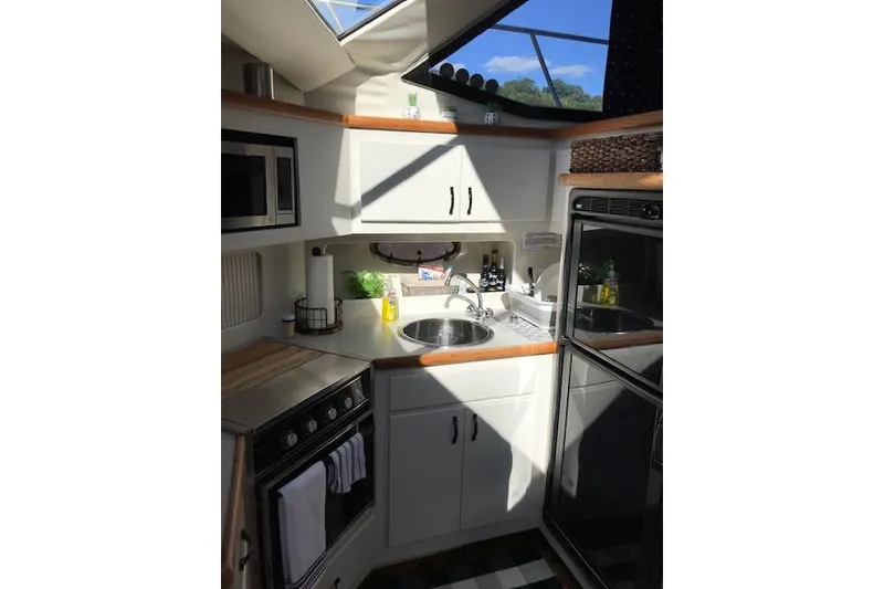 Slide: The Image of Interior of 1993 Carver 370 Aft Cabin Motor Yacht kitchen with appliances and sink. - 28