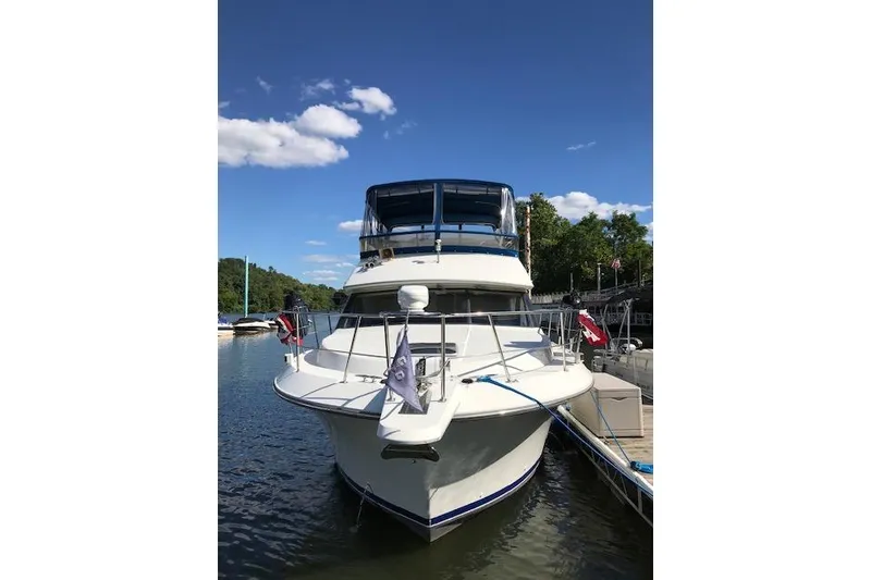 Slide: The Image of 1993 Carver 370 Aft Cabin Motor Yacht docked on a sunny day. - 4