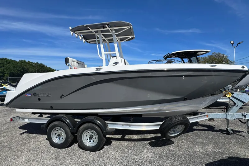 The Image of 2025 Yamaha Boats 222 FSH Sport on trailer, sleek design under clear blue sky. - 0