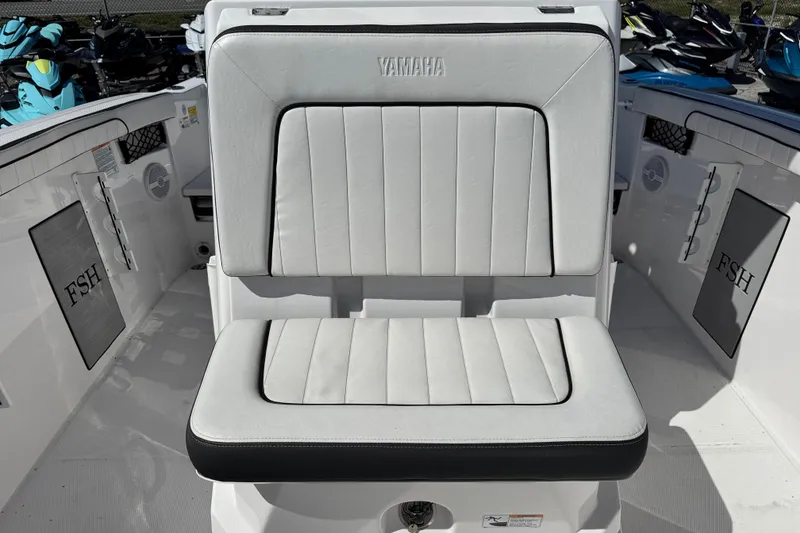 Slide: The Image of 2025 Yamaha Boats 222 FSH Sport interior seating, featuring sleek white upholstery and modern design. - 13