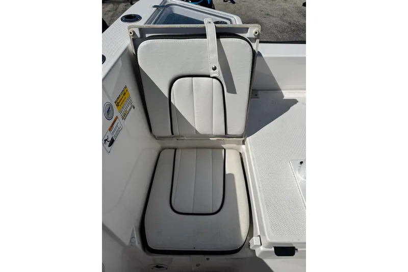 Slide: The Image of 2025 Yamaha Boats 222 FSH Sport seat with storage compartment open. - 15