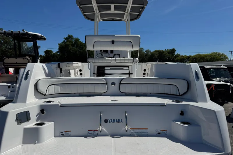 Slide: The Image of 2025 Yamaha Boats 222 FSH Sport, rear view, showcasing seating and deck features. - 2