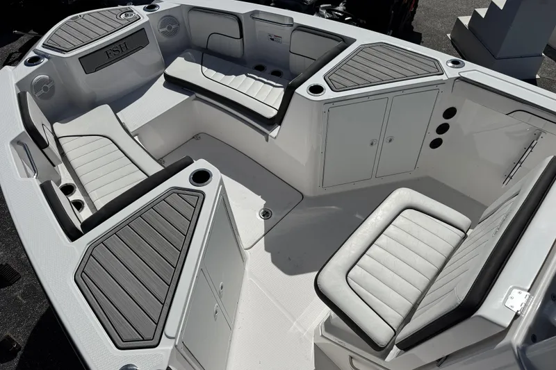Slide: The Image of 2025 Yamaha Boats 222 FSH Sport interior with cushioned seating and storage compartments. - 6