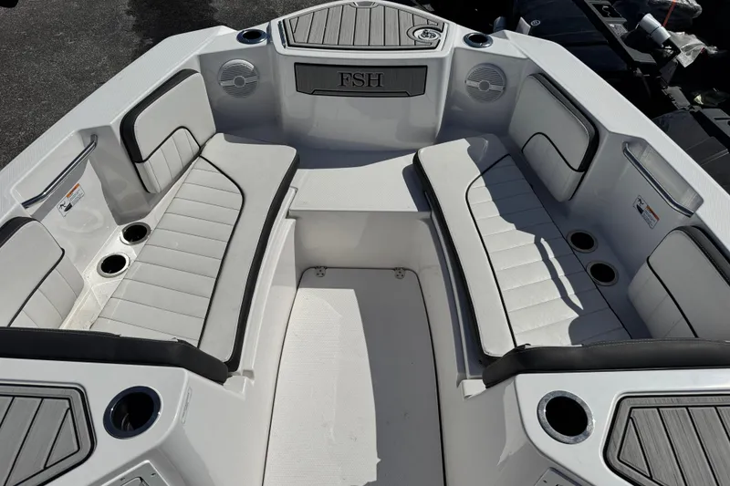 Slide: The Image of 2025 Yamaha Boats 222 FSH Sport interior with cushioned seating and cup holders. - 8