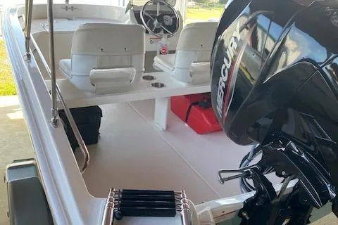 Slide: The Image of 2026 Boston Whaler 130 Super Sport boat interior with Mercury engine. - 3