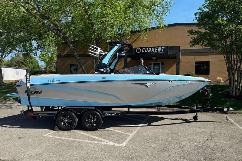 The Image of 2022 Tigé Z3 boat on trailer, parked outside Current Watersports building. - 1