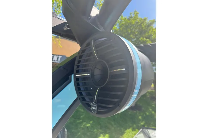 Slide: The Image of 2022 Tigé Z3 boat speaker, black with blue accents, mounted outdoors. - 11