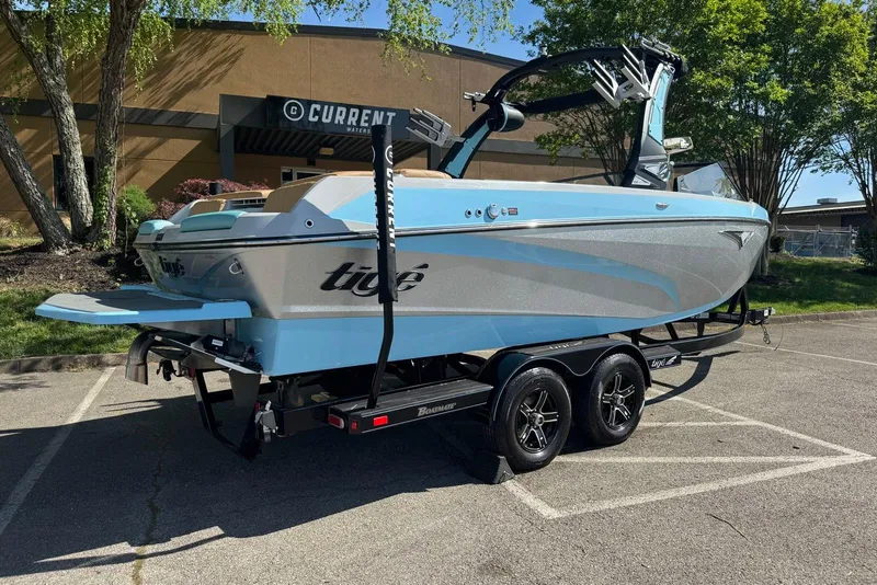 Slide: The Image of 2022 Tigé Z3 boat on trailer in parking lot, featuring sleek design and vibrant colors. - 3