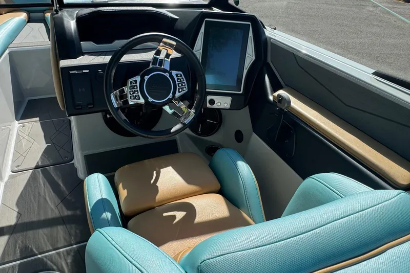 Slide: The Image of 2022 Tigé Z3 boat interior with modern steering wheel and touchscreen display. - 8