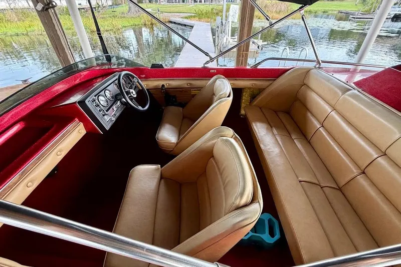 Slide: The Image of 1981 Glastron/Carlson C512 boat interior with tan seats and red dashboard. - 10