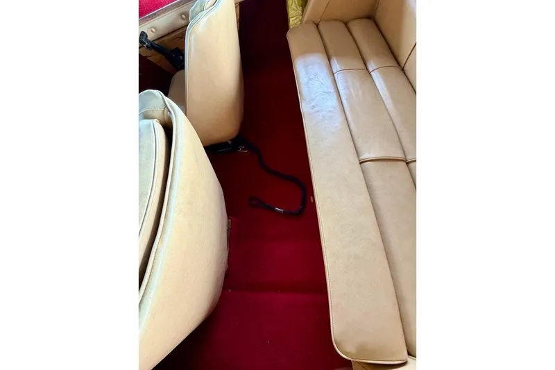 Slide: The Image of 1981 Glastron/Carlson C512 interior with beige seats and red carpet. - 12