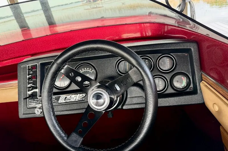 Slide: The Image of 1981 Glastron/Carlson C512 boat dashboard with steering wheel and gauges. - 19